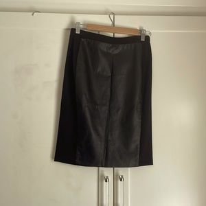 Straight cut skirt with leather panel. There is a crease in the leather.